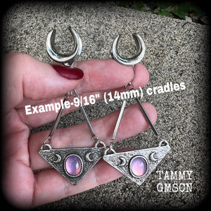 Featuring an inverted triangle with crescent moons and a single translucent purple cabachon, measuring just over 7 cms from tip to tip, and weighing approx 8 grams each.
This pair has been made on 14mm surgical steel cradles