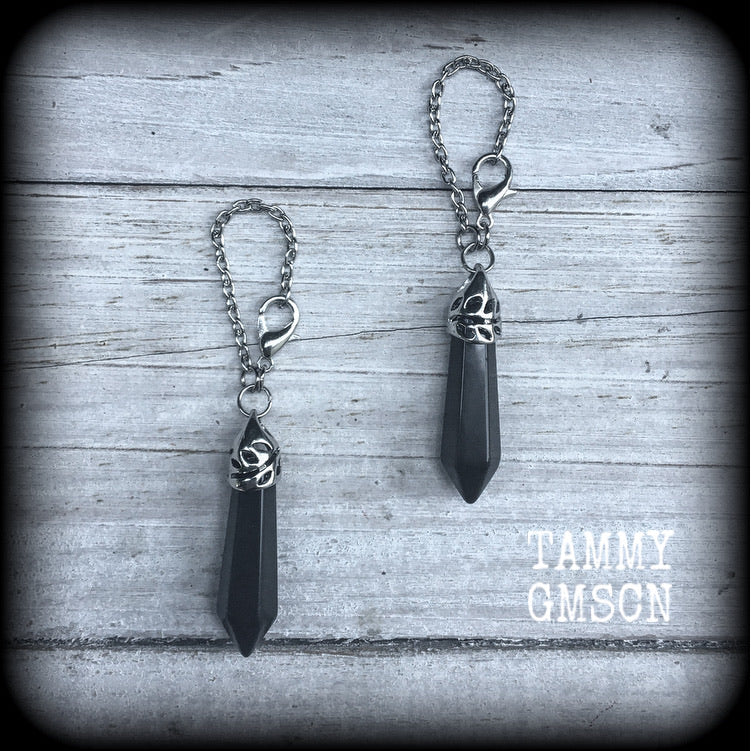 This gorgeous pair of pitch black obsidian earrings are nice and lightweight and nice and dangly, measuring just on 6cms from tip to tip and weighing in at 5 grams each piece.
This pair have been made on our super versatile antique silver chain and lobster clasp 4mm option, to be worn through silicone earlets in stretched lobes from 6 gauge (4mm).