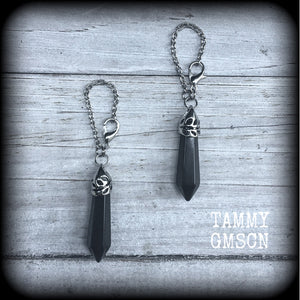 This gorgeous pair of pitch black obsidian earrings are nice and lightweight and nice and dangly, measuring just on 6cms from tip to tip and weighing in at 5 grams each piece.
This pair have been made on our super versatile antique silver chain and lobster clasp 4mm option, to be worn through silicone earlets in stretched lobes from 6 gauge (4mm).