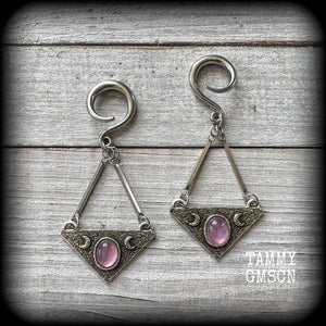 Featuring an inverted triangle with crescent moons and a single translucent purple cabachon, measuring just over 7 cms from tip to tip, and weighing approx 8 grams each.
This pair has been made on 6 gauge (4mm) surgical steel full curl hooks.