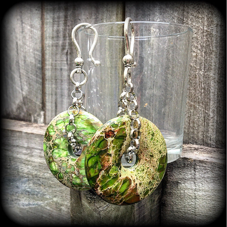 Featuring lime green ocean jasper donut gemstones, these earrings weigh in at approx 35 grams a piece, and hang just on 10cms from tip to tip.
This pair has been made with large antique silver shephard hooks, for stretched ears.