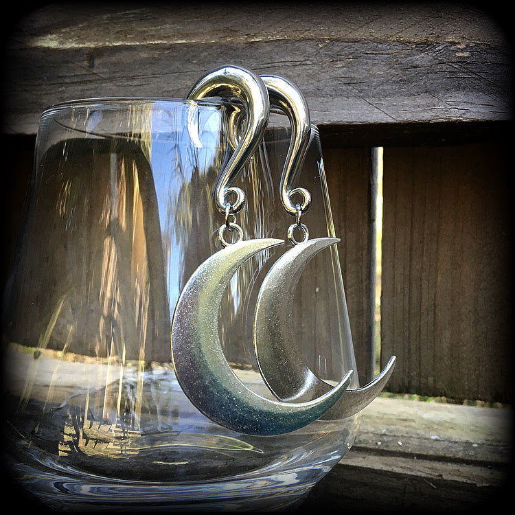 These gorgeously witchy antique silver 'Crescent moon' gauged earrings feature a classic antique silver crescent moon, measuring just under 8cms from tip to tip, and weighing approx 15 grams each.

This pair has been made on 0 gauge (8mm) surgical steel half curl hooks, to be worn in stretched lobes.