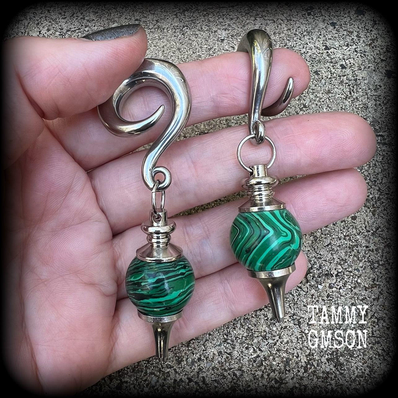 These gorgeous earrings feature deep green Malachite pendulums, weighing in at approx 26 grams each, and measure just on 8 cms from tip to tip, nice and dangly.

This pair has been made with 0 gauge (8mm) surgical steel full curl hooks, suitable for stretched lobes. 