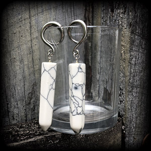 These earrings are made with beautiful white howlite stone points, measuring just on 8cms from tip to tip, and weighing approx 13grams each.
This pair has been made on 6 gauge (4mm) surgical steel full curl hooks, to be worn in stretched lobes.