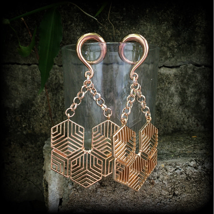 These gauged earrings feature beautiful rose gold tone geometric hexagon pendants, measuring just over 10cms from tip to tip, and weighing approx 22 grams each.
This pair has been made on 2 gauge (6mm) surgical steel full curl hooks.