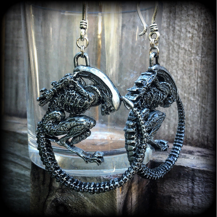 These awesome earrings feature a pair of large pewter Alien Queen Xenomorphs, measuring 9cms from tip to tip (nice and big), and weigh 38 grams each (these are HEAVY).

This pair have been made on small antique silver shephard hooks to be worn in stretched lobes with silicone earlets from 8 gauge (3mm).