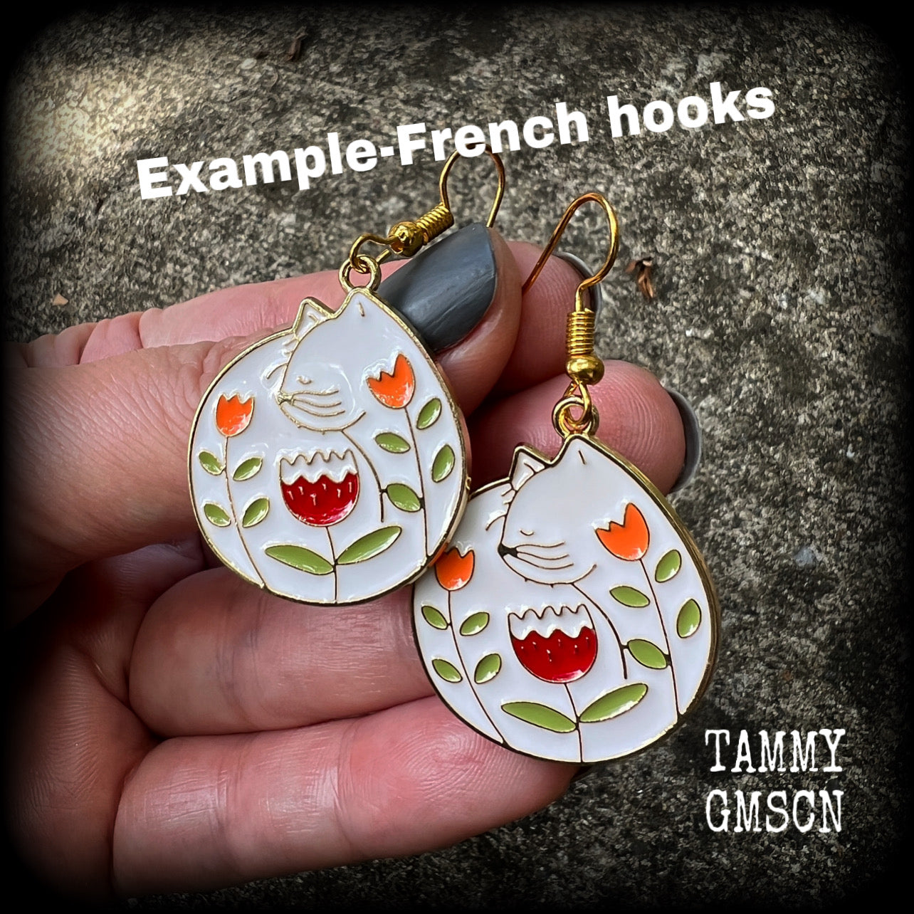These adorably quirky earrings feature gorgeous folk art inspired cat and tulip charms.
Measuring 5cms from tip to tip, these earrings are nice and lightweight at only 4 grams each.
This pair has been made on antique gold french hooks, to be worn in pierced ears.