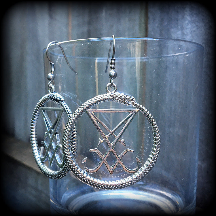 These gorgeous antique silver 'Ouroboros and Sigil of Lucifer' earrings are light weight at approx 5 grams a piece, and nice and dangly, measuring just over 5cms from tip to tip.
This pair has been made with stainless steel french hooks, suitable for pierced ears.