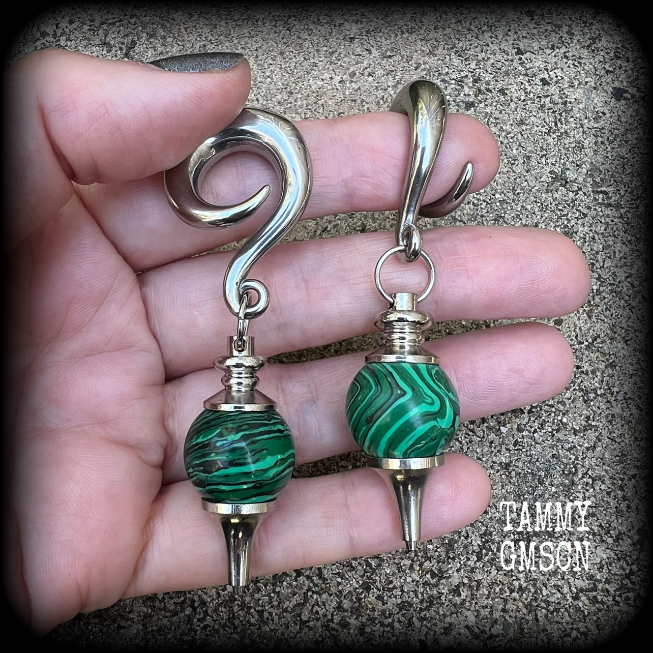 These gorgeous earrings feature deep green Malachite pendulums, weighing in at approx 26 grams each, and measure just on 8 cms from tip to tip, nice and dangly.

This pair has been made with 0 gauge (8mm) surgical steel full curl hooks, suitable for stretched lobes. 