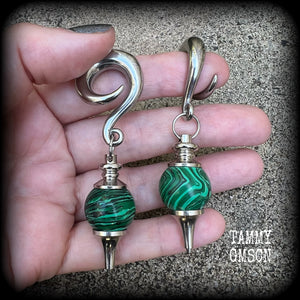 These gorgeous earrings feature deep green Malachite pendulums, weighing in at approx 26 grams each, and measure just on 8 cms from tip to tip, nice and dangly.

This pair has been made with 0 gauge (8mm) surgical steel full curl hooks, suitable for stretched lobes. 