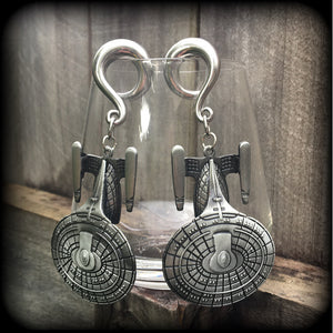 These gorgeous gauged earrings feature the Star Trek USS Enterprise, measuring just on 10cms from tip to tip and weighing approx 45 grams a piece, these earrings are BIG, DANGLY and HEAVY.

This pair has been made on 0 gauge (8mm) surgical steel full curl hooks, to be worn in stretched lobes.
