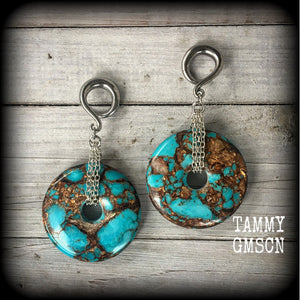 These earrings feature sky blue turquoise and bronzite gemstones cradled in antique silver chain. This pair weighs approx 32 grams a piece, and measure 10cms from tip to tip.
These have been made on 6 gauge (4mm) surgical steel full curl hooks.