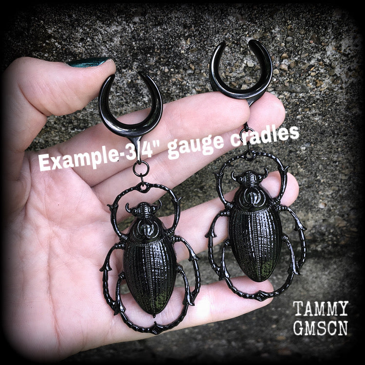 These gorgeous black enamel 'Scarab beetle' gauged earrings measure approx 9cms from tip to tip, and weigh approx. 16 grams a piece, not too heavy.
This pair has been made on 3/4" gauge (19mm) gauge surgical steel cradles, to be worn in stretched lobes.