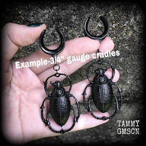 These gorgeous black enamel 'Scarab beetle' gauged earrings measure approx 9cms from tip to tip, and weigh approx. 16 grams a piece, not too heavy.
This pair has been made on 3/4" gauge (19mm) gauge surgical steel cradles, to be worn in stretched lobes.