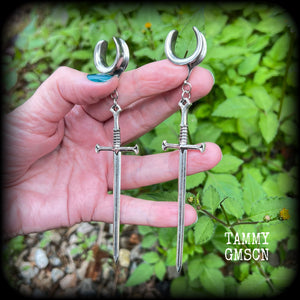 Our 'Ace of Swords' ear hangers feature a gorgeous long antique silver sword pendant, measuring just over 12cms from tip to tip, and weighing approx 9 grams each.

This pair has been made on 9/16" (14mm) surgical steel cradles, to be worn in stretched lobes.