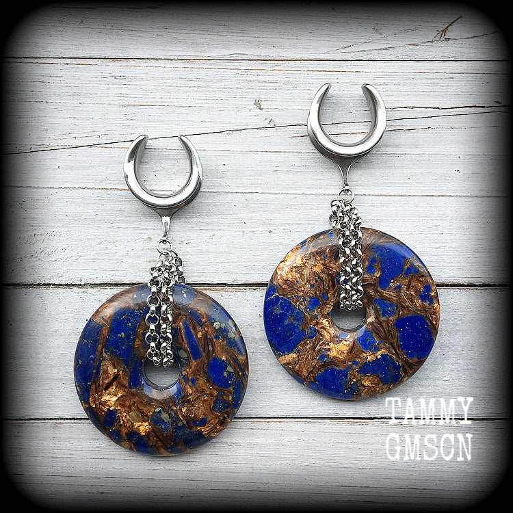 Featuring a pair of gorgeous dark blue lapis lazuli and bronzite donut gemstones cradles in stainless steel chain, this pair of ear hangers weigh approx 34 grams a piece, and measure just under 10cms from tip to tip.

This pair have been made on 7/8" (22mm) gauge surgical steel cradles, for stretched lobes.