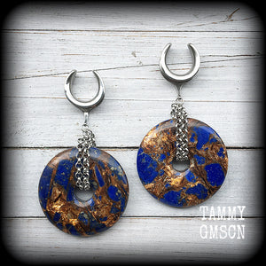 Featuring a pair of gorgeous dark blue lapis lazuli and bronzite donut gemstones cradles in stainless steel chain, this pair of ear hangers weigh approx 34 grams a piece, and measure just under 10cms from tip to tip.

This pair have been made on 7/8" (22mm) gauge surgical steel cradles, for stretched lobes.