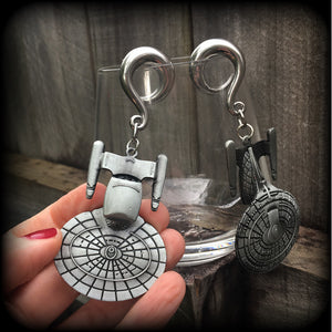 These gorgeous gauged earrings feature the Star Trek USS Enterprise, measuring just on 10cms from tip to tip and weighing approx 45 grams a piece, these earrings are BIG, DANGLY and HEAVY.

This pair has been made on 0 gauge (8mm) surgical steel full curl hooks, to be worn in stretched lobes.
