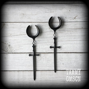 These gorgeous ear hangers feature a pitch black enamel sword pendant, measuring just on 12cms from tip to tip, and weighing approx 12 grams each.
This pair has been made on 1" (25mm) surgical steel cradle hooks, to be worn in stretched lobes.